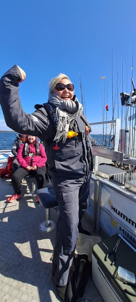 Tiina holding a boat
